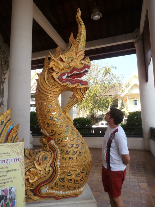 Chiang Mai has dozens of "wats" (temples). Here I am at one of them. Photographer Kat's direction for this photo was "Dave, look at the dragon! Consider him..."